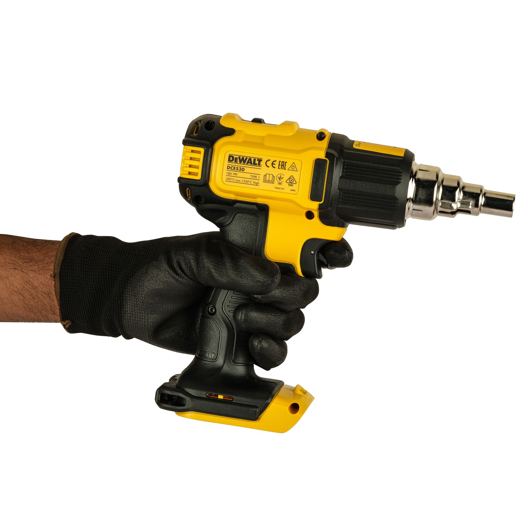 A DEWALT DCE530N cordless heat gun being held in a gloved hand, showing the yellow and black tool with a metal nozzle against a white background.