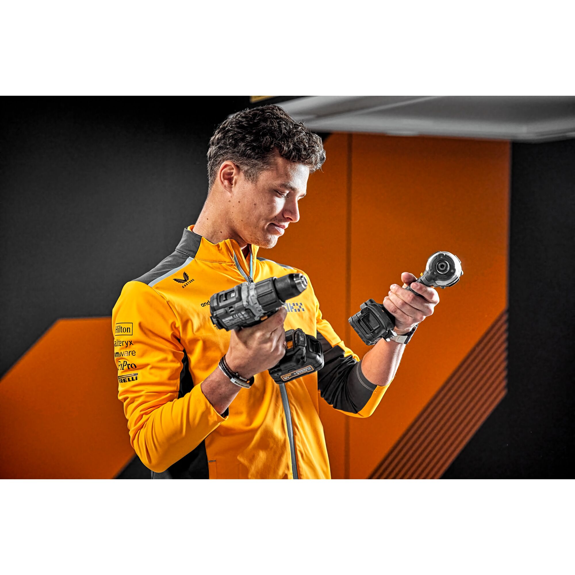McLaren driver Lando Norris holding Limited Editon DEWALT/McLaren Drill Drivers