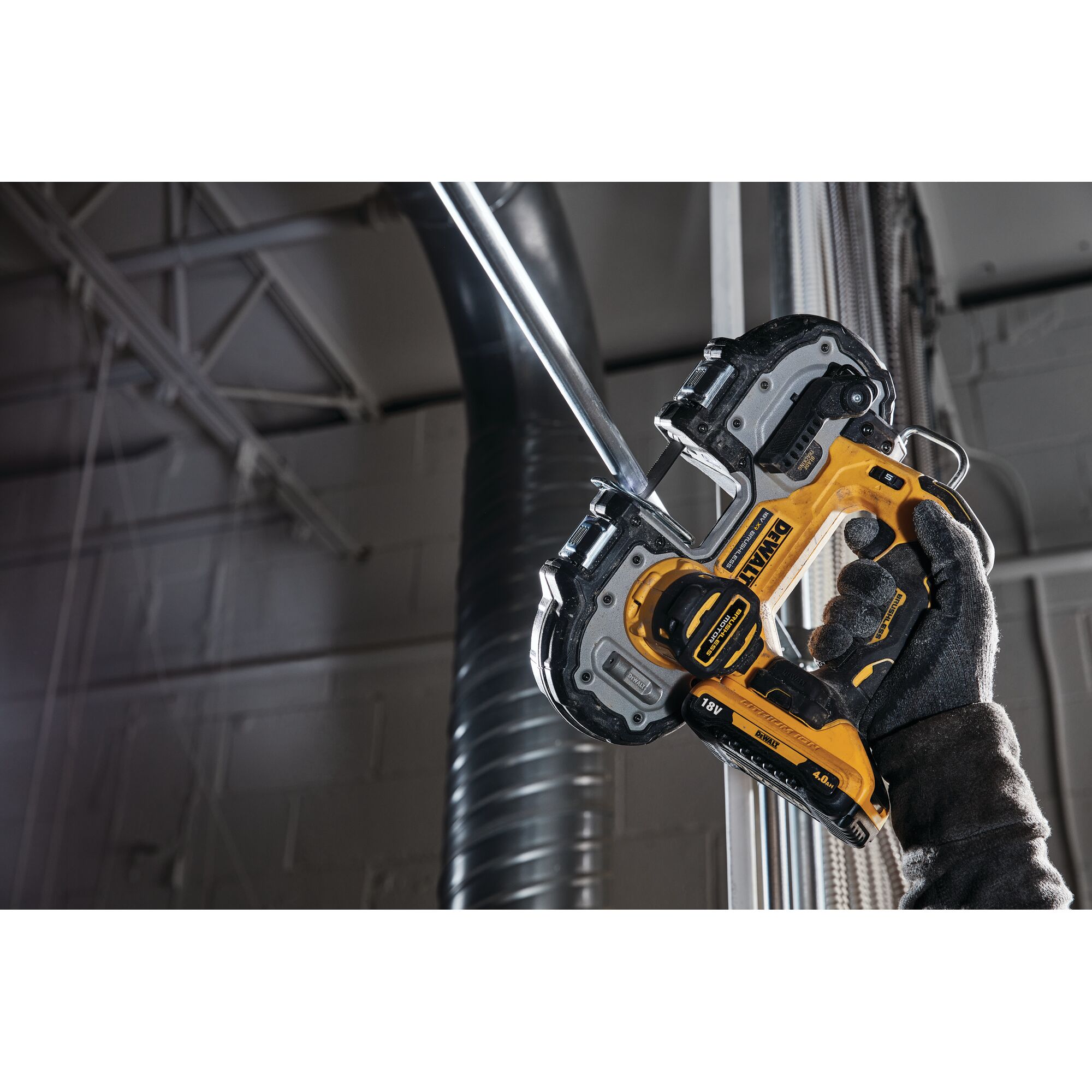 A DEWALT cordless band saw cutting a metal pipe, held by a gloved hand in an industrial setting.
