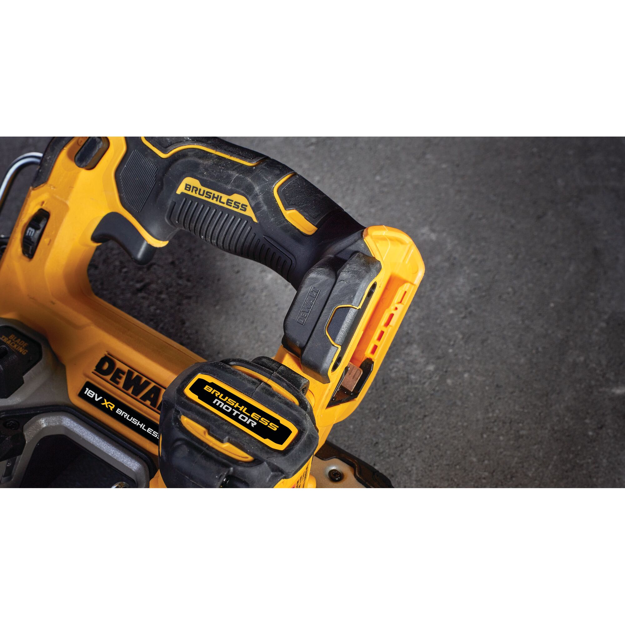 Close-up of a DEWALT brushless motor power tool handle, showing yellow and black details on a dark surface.