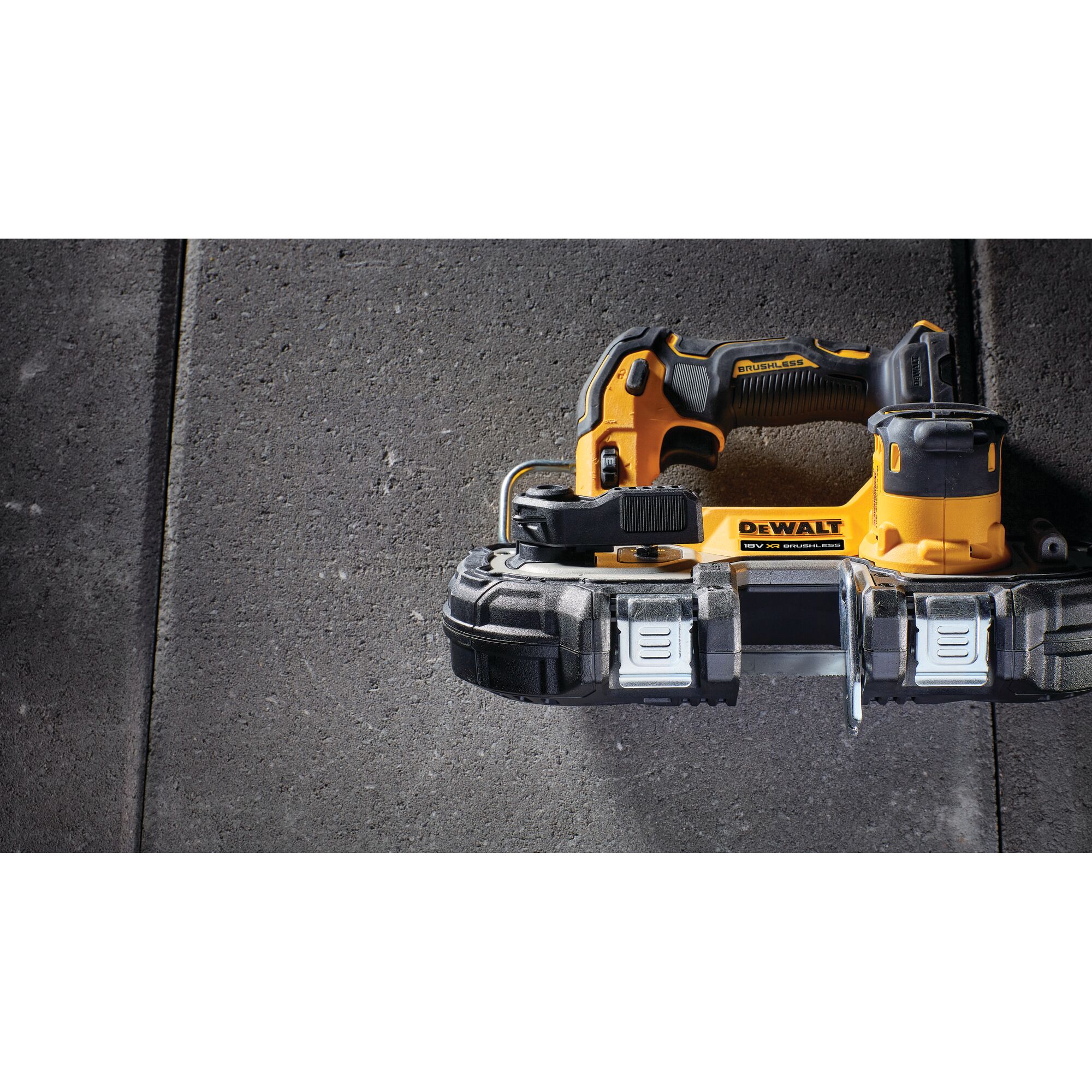 DEWALT cordless handheld bandsaw tool on a stone surface, shown from above.