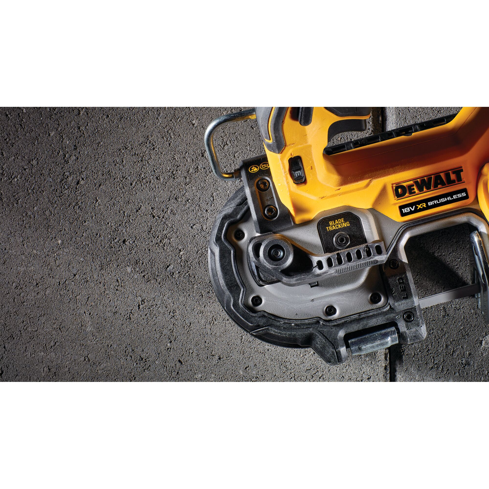 Close-up of a DEWALT 18V XR brushless tool on a concrete surface.