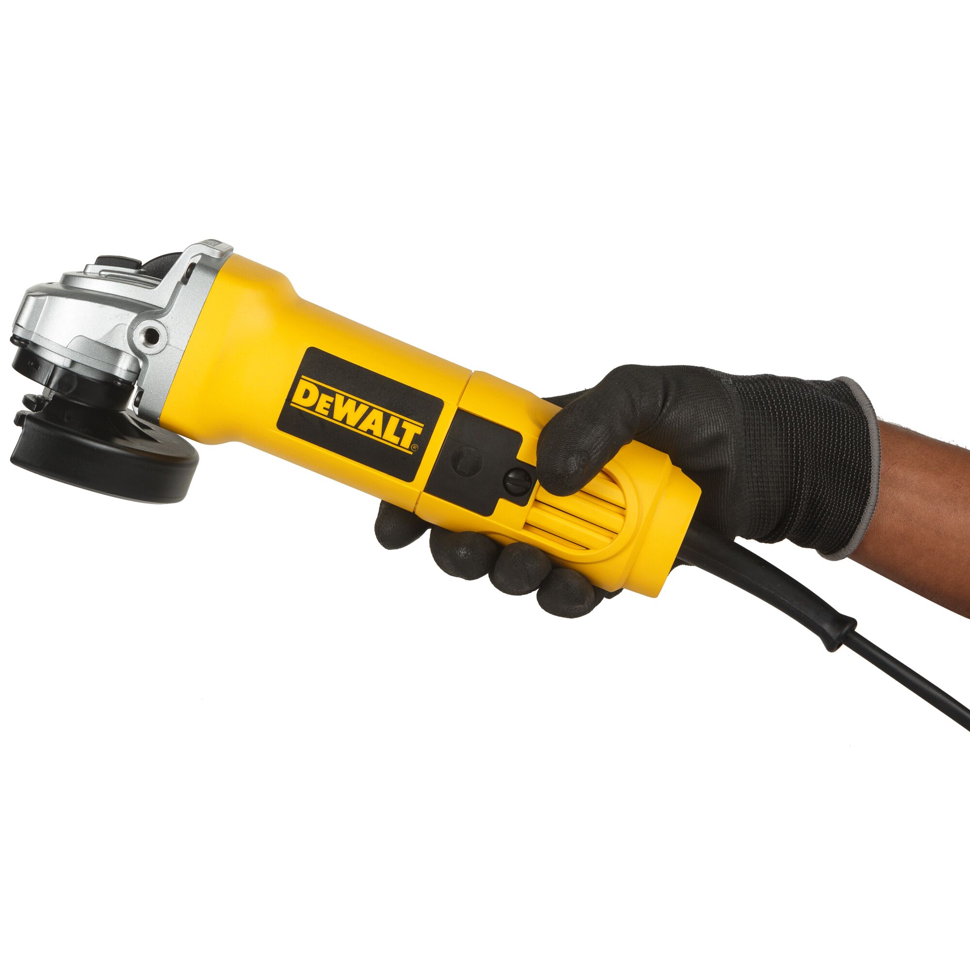 A yellow DEWALT DW803 angle grinder held in a gloved hand, with its power cord visible, photographed against a white background.