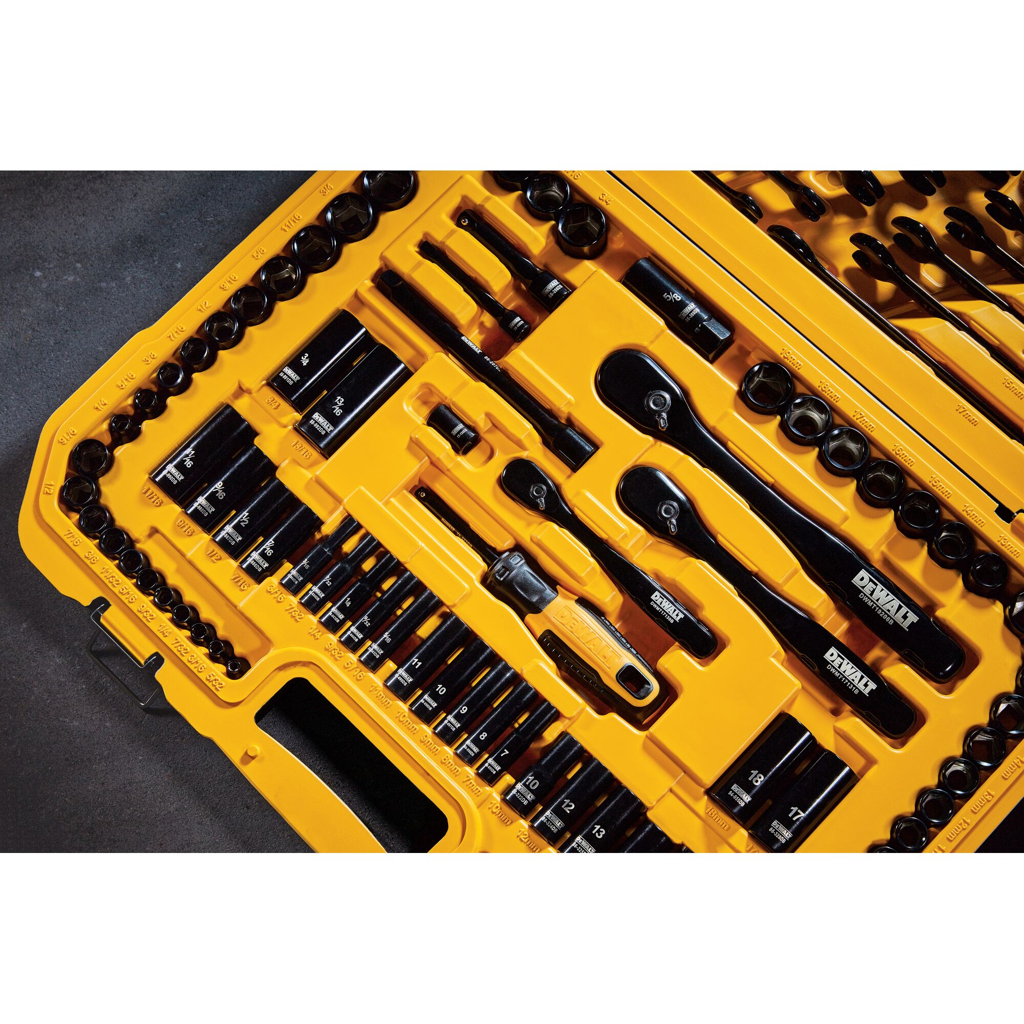 Close-up view of a DEWALT yellow tool case containing an organized set of socket wrenches, ratchets, and various drive bits, displayed neatly in their designated slots.